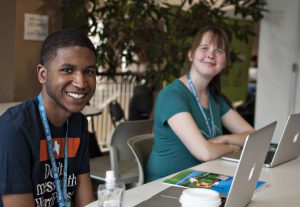 Young man and young woman with laptops at WordCamp Minneapolis
